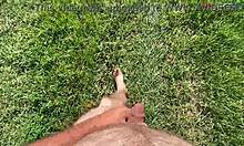 barefoot cutie teases feet while stroking cock outdoors this fall