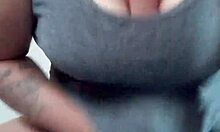 tattooed brunette teases dildo between her natural breasts playfully