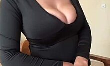 big milky tits straining against black dress fabric