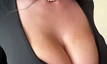 big milky tits straining against black dress fabric