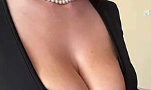 big milky tits straining against black dress fabric
