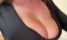 big milky tits straining against black dress fabric