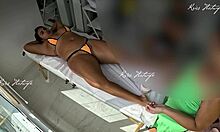 she slips tiny bikini into her big pussy during tanned massage
