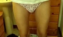 She soaks her panties peeing while teasing in lingerie and stockings