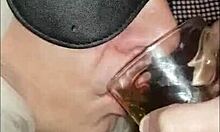 blindfolded bisexual crossdresser drinks his own pee fed by girlfriend close-up