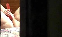hey peeped this milf fingering hard at hotel window