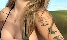 tattooed blonde babe flaunts her assets outdoors
