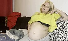 Chubby mommy gets swollen belly massaged on couch