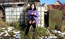 Cute milf smokes and shows naked pussy with dildo outdoors