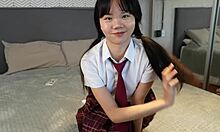 Playful asian student in uniform loves getting cuffed