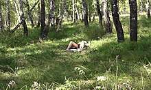 A girl masturbates in forest knowing someone watches outdoors