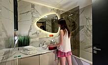 Long legs nerdy college girl with a short pink skirt and pink panties show off in the bathroom