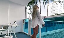 blonde big tit babe plays with pussy on public hotel balcony