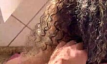 Curly blonde dances funk in pajamas in the kitchen