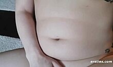 ella spreads her legs on the living room chair for a comfortable pose