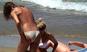 brunette with a stunning ass rubs oil on herself at the beach