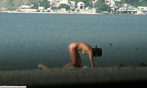 Gorgeous Brunette Nudist Emerges from Water, Captured by Voyeur