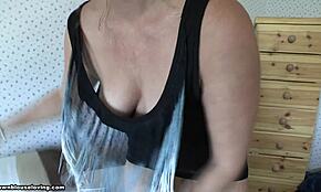 mature blonde wife poses in bedroom, showing big tits with wavy hair