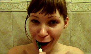 extremely happy chick brushing her teeth in the nude