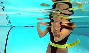 Katya Nakolkina swims underwater in the pool as a brunette babe