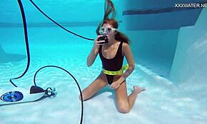 Katya Nakolkina swims underwater in the pool as a brunette babe