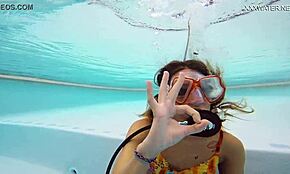 Katya Nakolkina swims underwater in the pool as a brunette babe