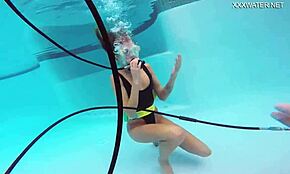 Katya Nakolkina swims underwater in the pool as a brunette babe