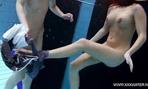 shaved brunette with big tits enjoys underwater lesbian fun in the pool