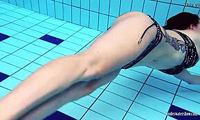 Redheaded Katrin strips underwater in a teasing solo show