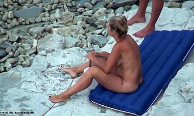 yo, check this blond chick posing all naked on a nudist beach, so hot! 🏖️