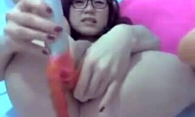 does this asian brunette finger her pussy with a toy in her asshole?
