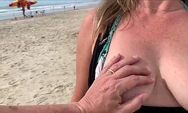 I'm cumming right in front of everyone at the beach again. People are staring while I blow this huge cock with my tits out!